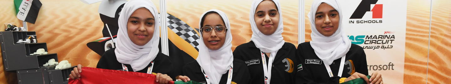 A group of students standing with UAE flag